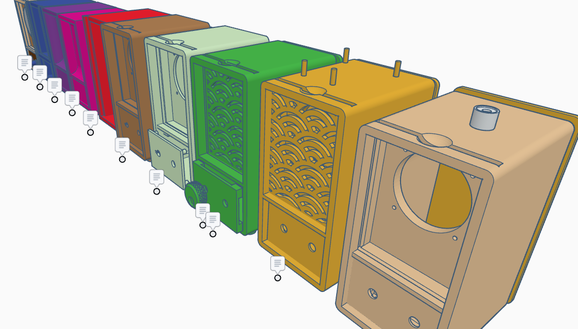 Close view of several colorful TinkerCAD radio enclosure iterations with grille and case variations